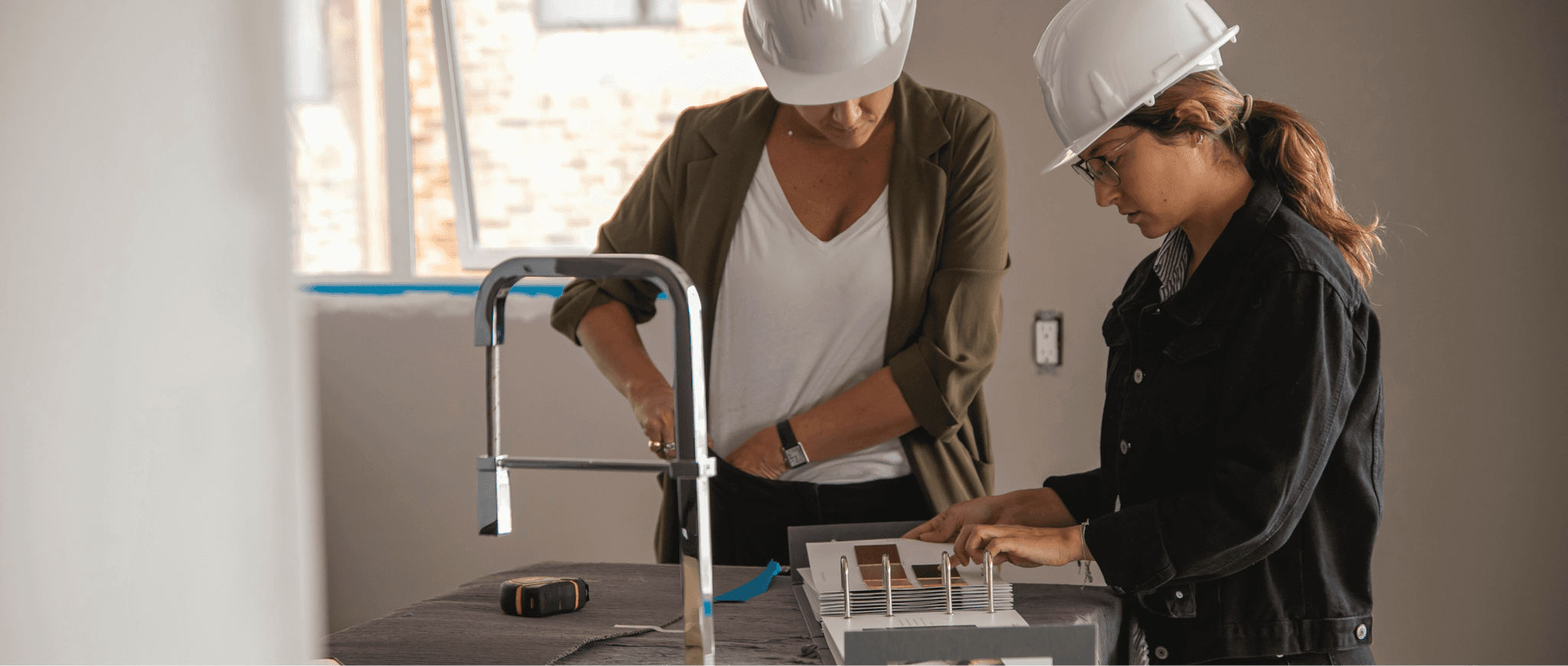 The Biviano team reviewing project plans and finishes with a homeowner